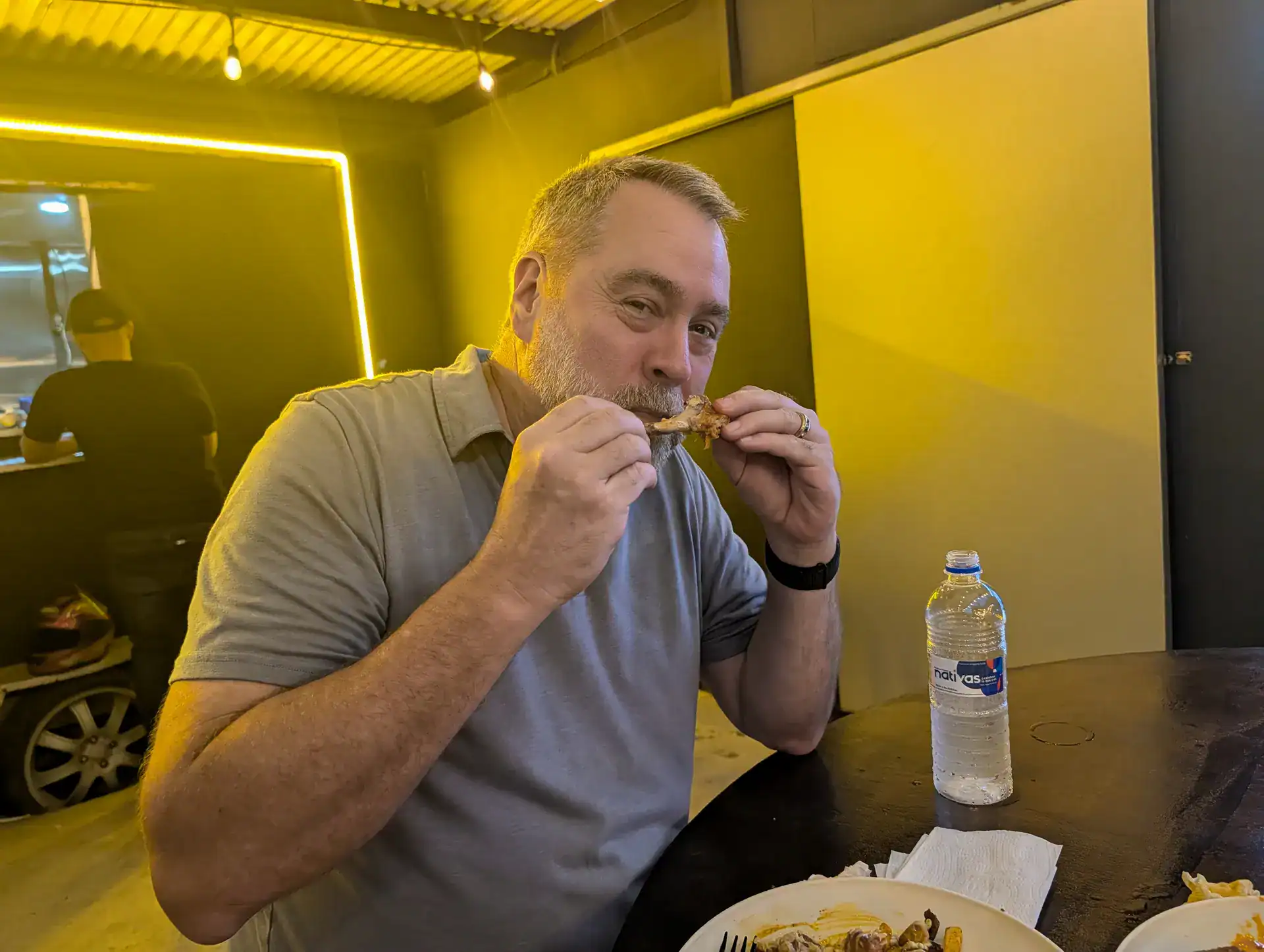 Kent eating wings at PotatoUs food container restaurant Panama City