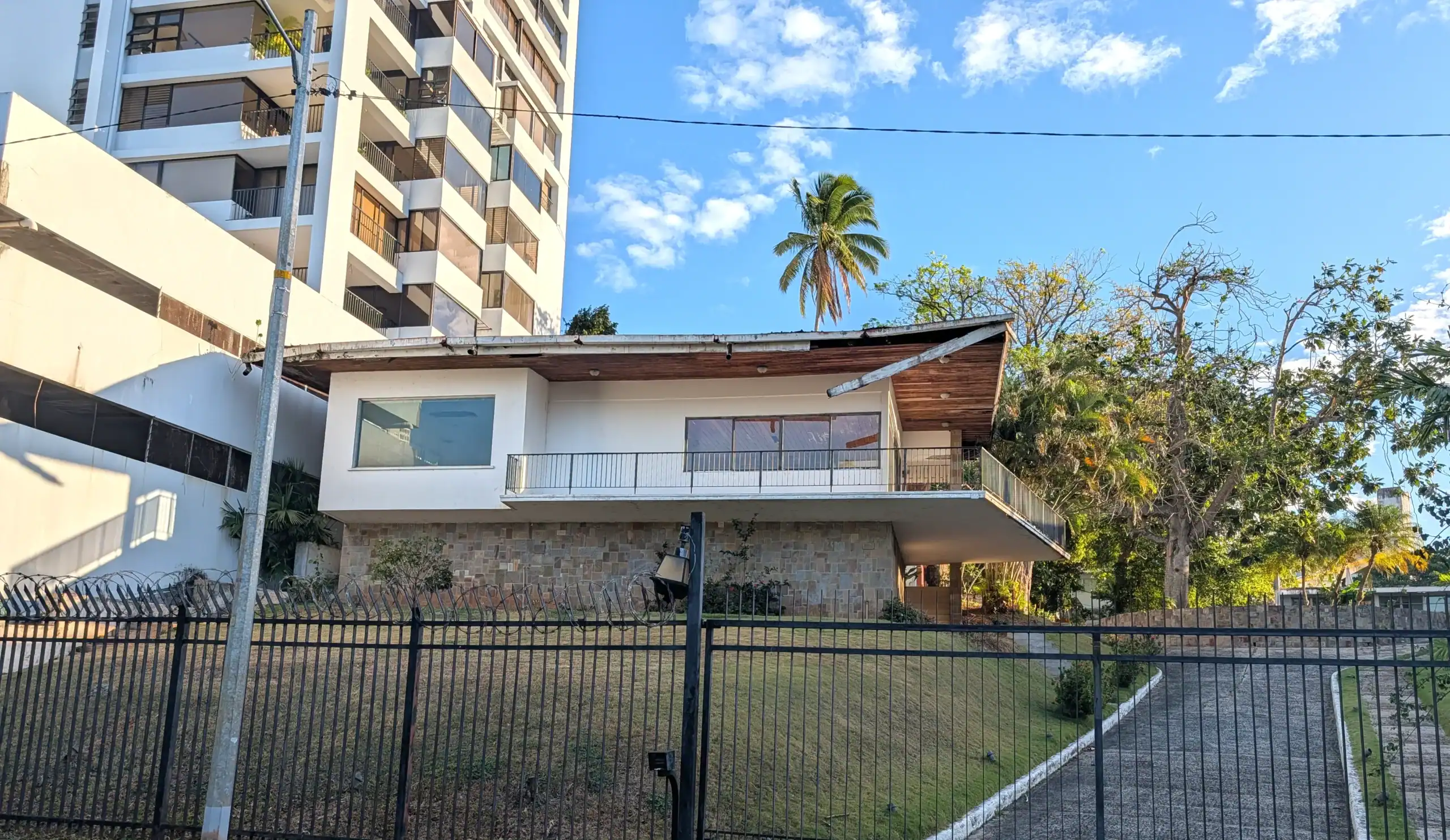 A La Cresta home sharing a gated lot with two others, with a high-rise condo built directly adjacent